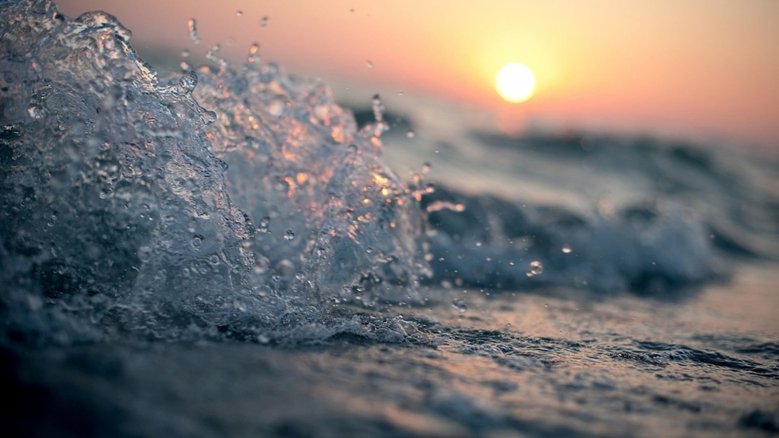 wave selective focus photography of water splash during sundown 2k
