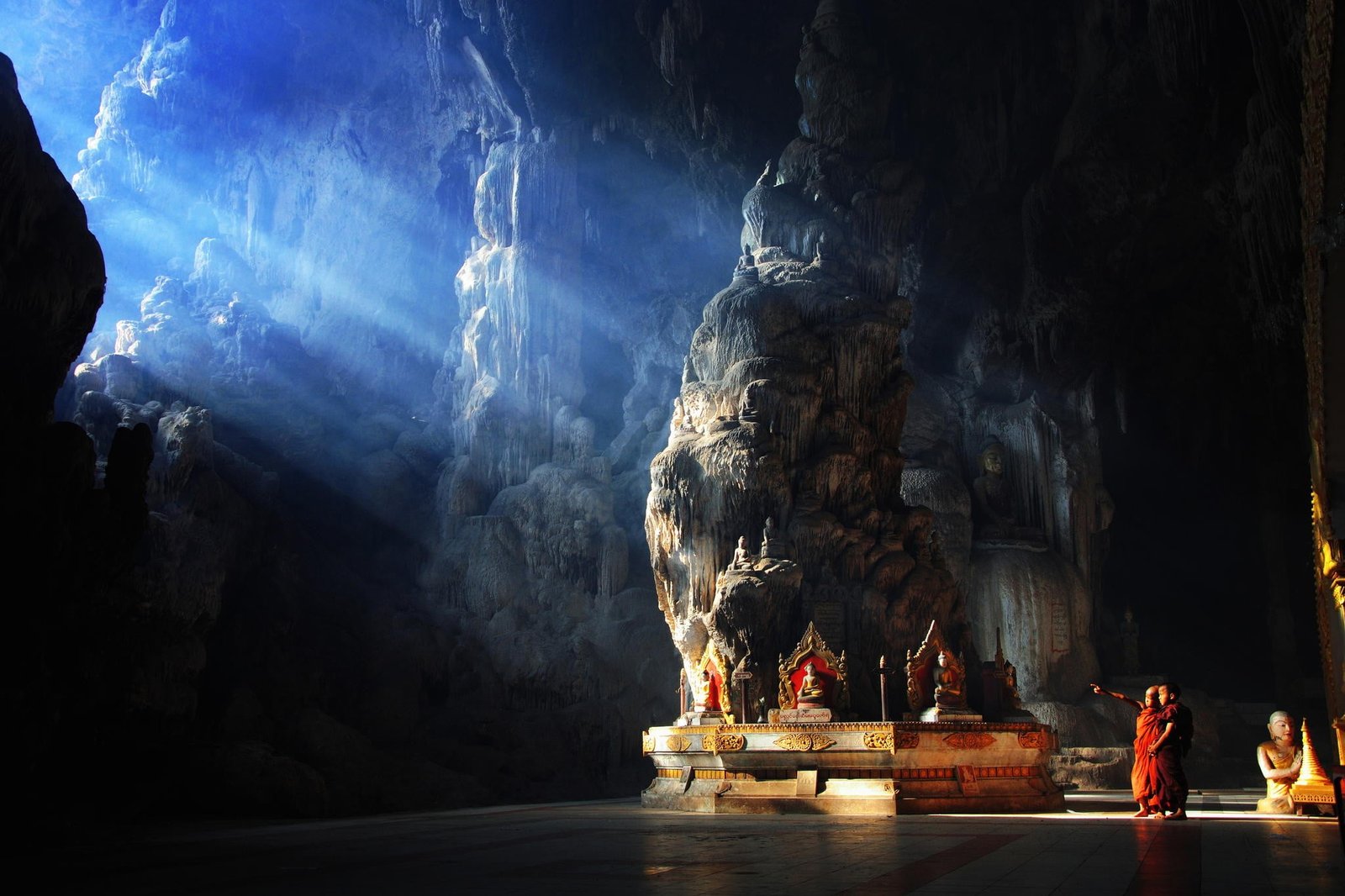 red kasaya suit nature cave monks Buddhism rock Myanmar 2k