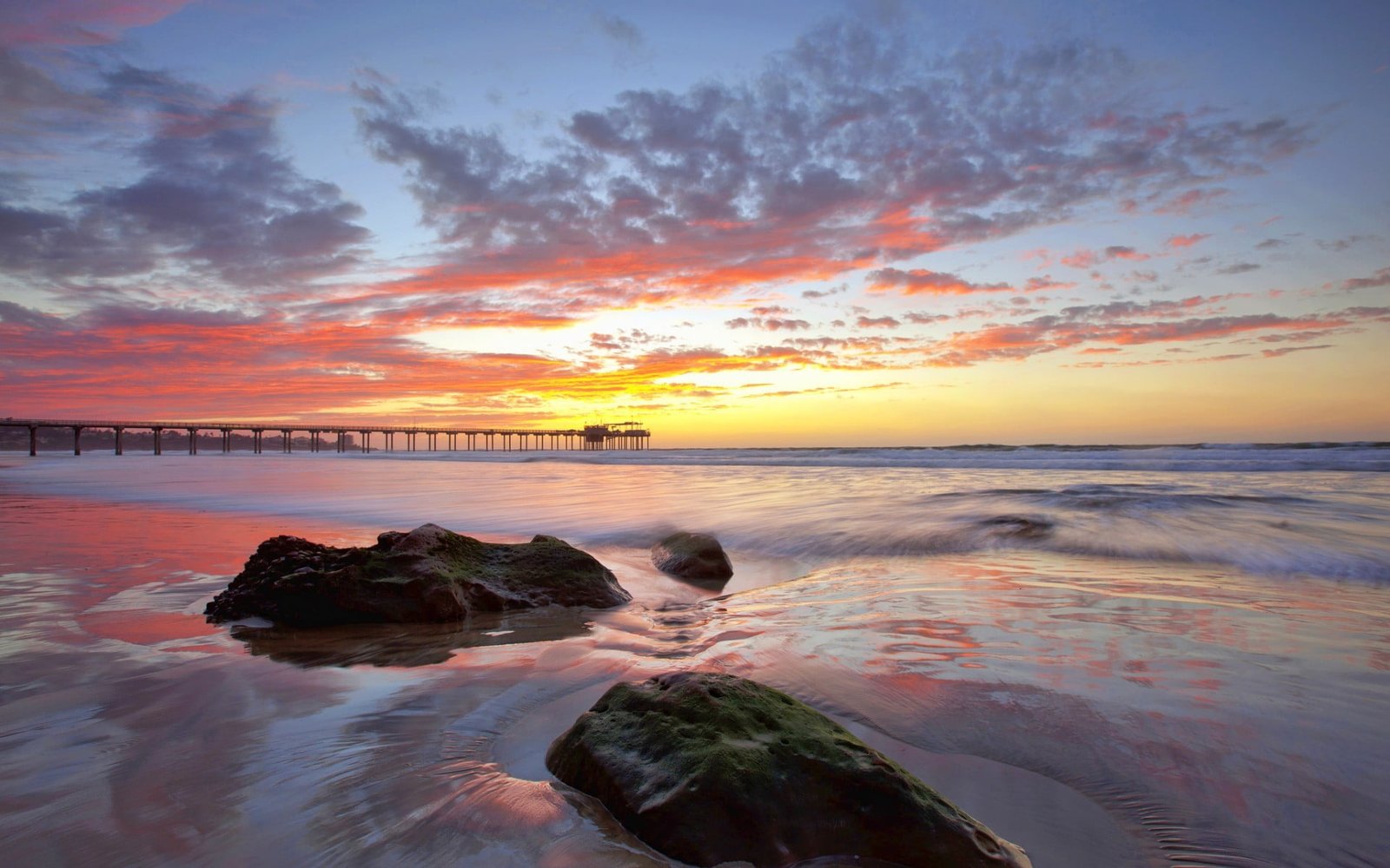 rocks in seashore during golden hour beach sky horizon pier 2k