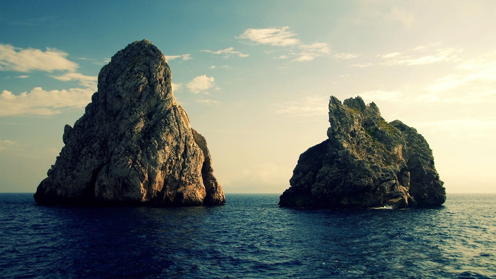 two rock formation in the middle of sea island clouds nature 2k