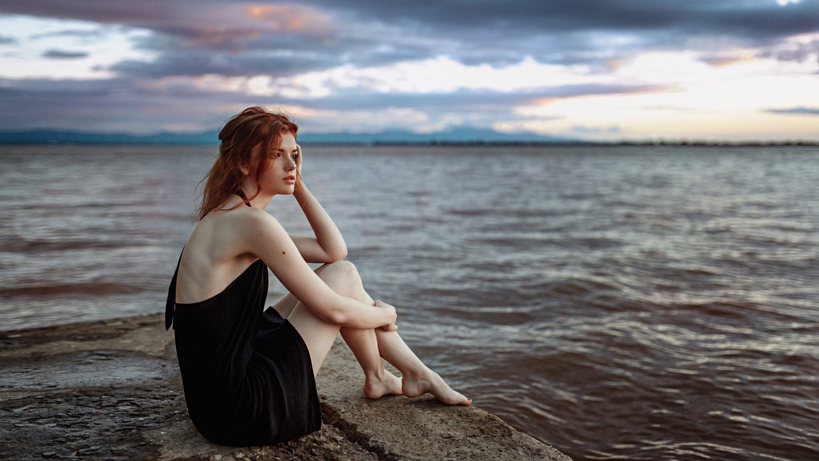 women's black sleeveless dress redhead pale sky feet water 2k