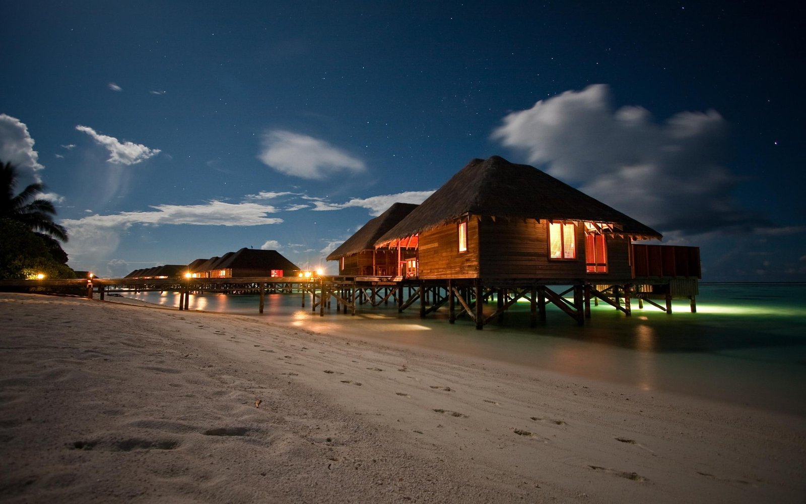 A Night On The Beach brown wooden beach houses palms tropical 2k