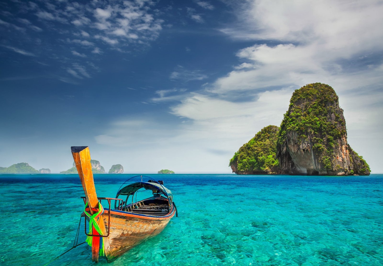 brown wooden canoe sea Halong Bay island rock Railay Beach 2k