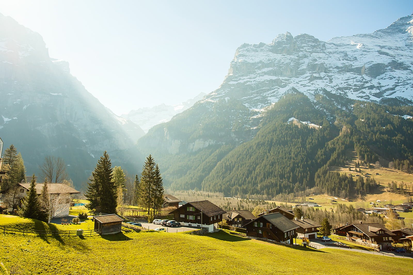 landscape photograph of town near mountains grindelwald switzerland 2k