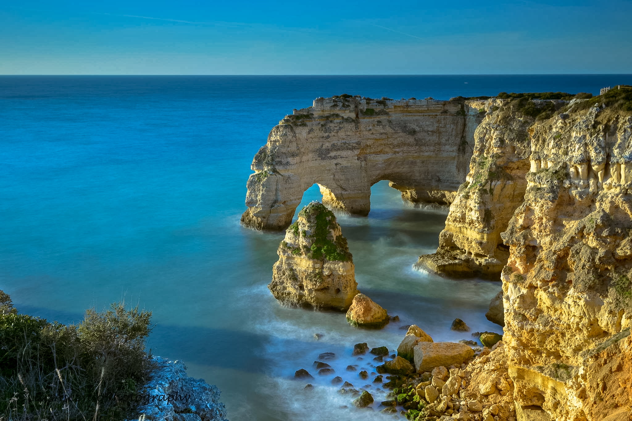 aerial view of rock formation and cliff beside blue ocean algarve 2k