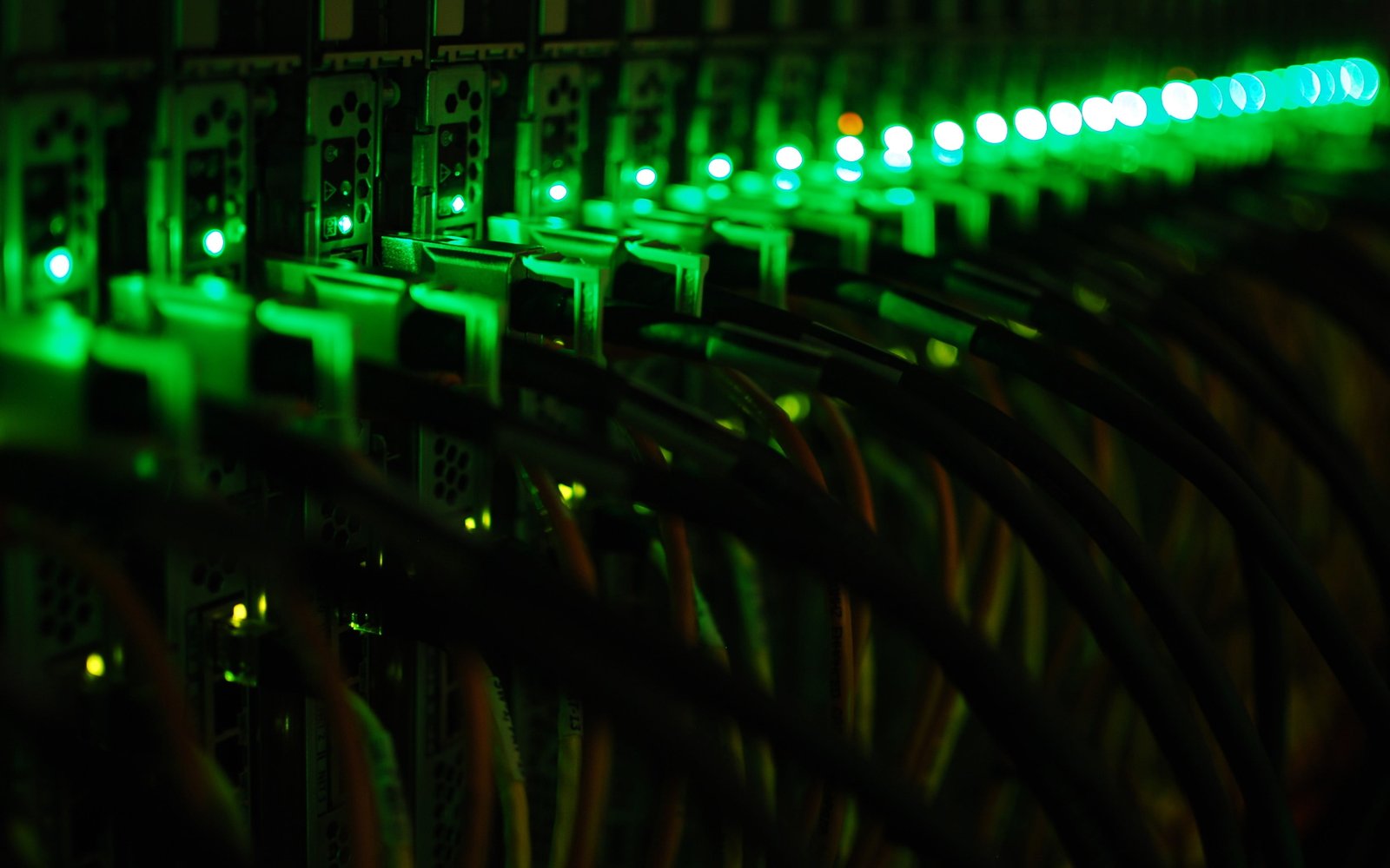 black computer cables coated with green lighted LEDs 2k 4k