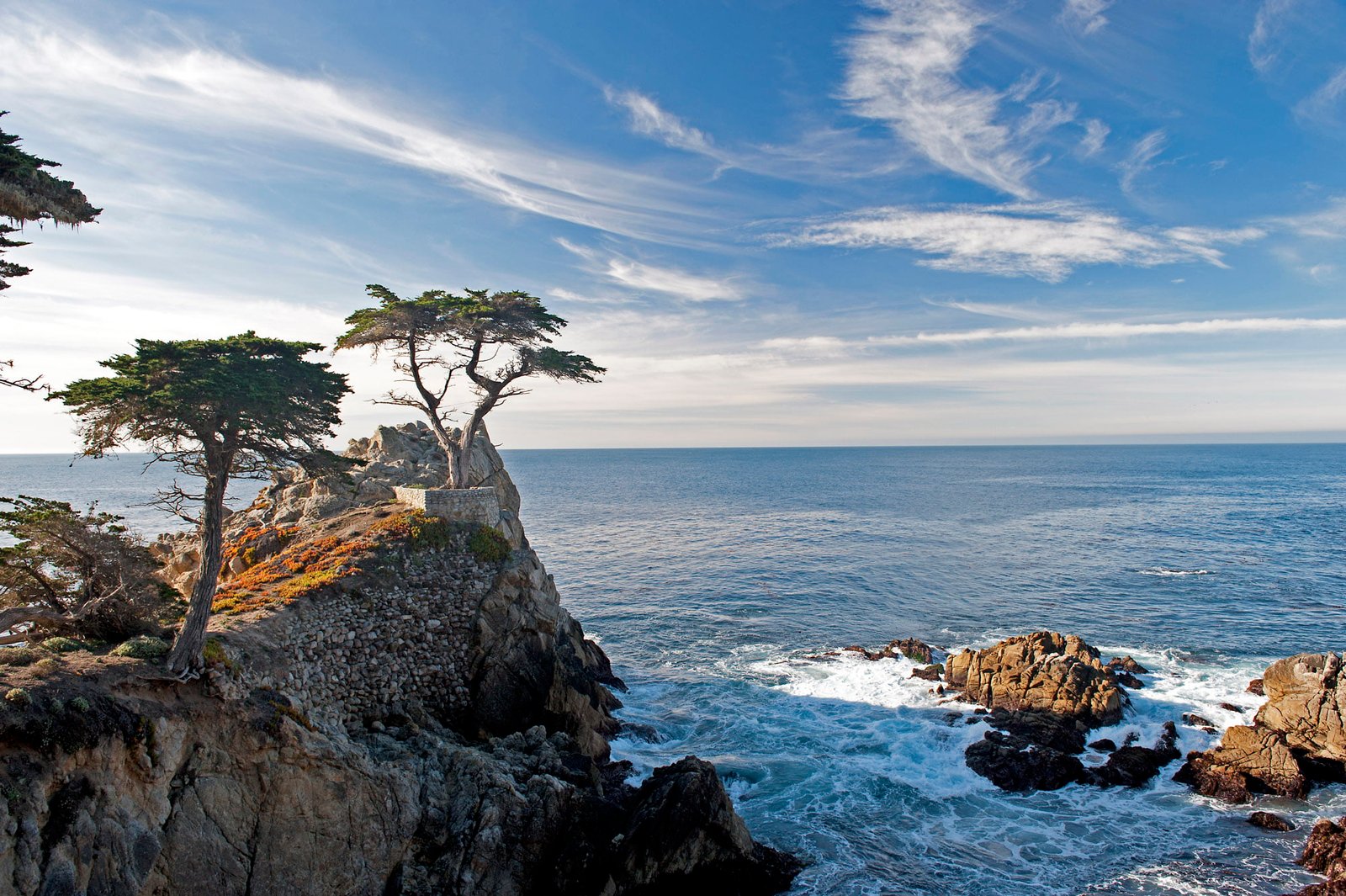 cliff near body of water under white cloudy sky during daytime lone cypress monterey 2k