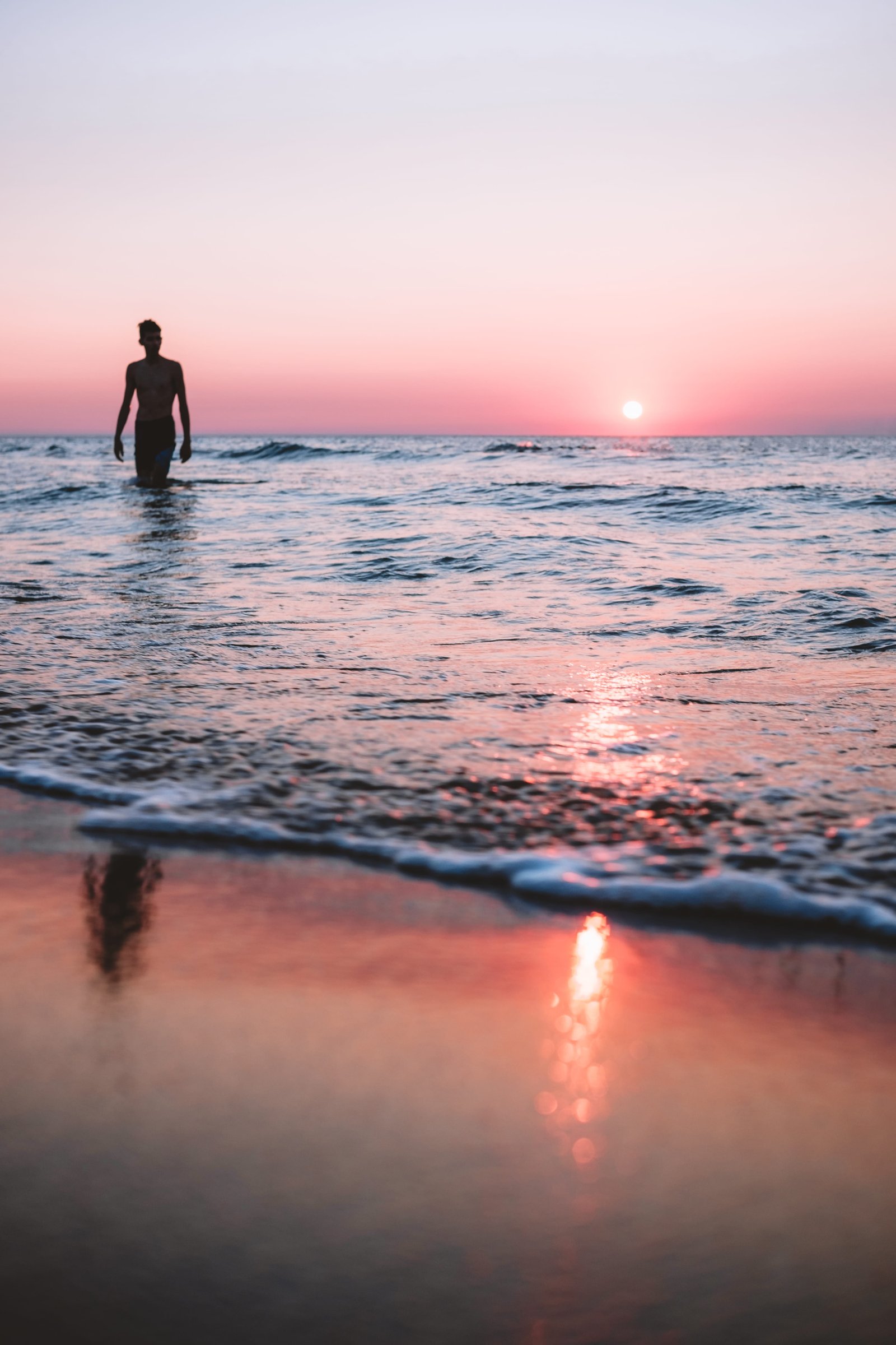Loner beach ocean sunset moody sea portrait 2k