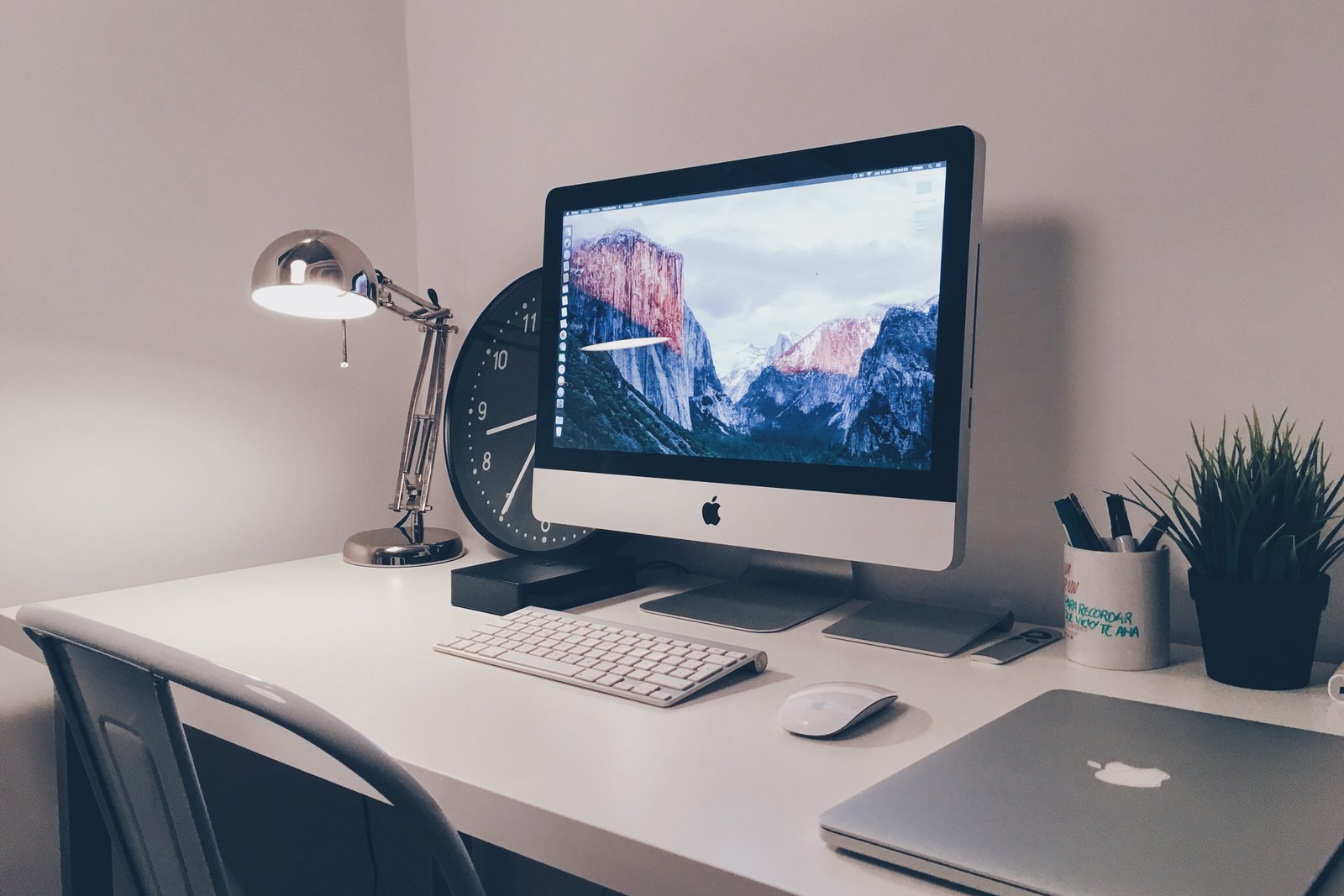 iMac computer and laptop on white office desk table technology 2k 4k