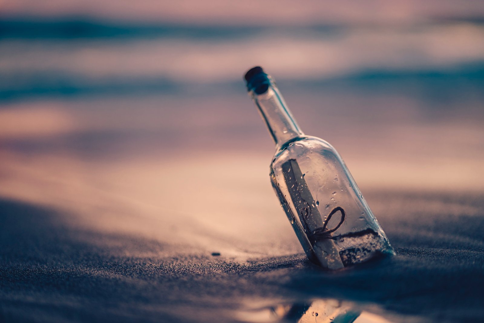 clear glass bottle on sand beach coast shore message adventure 2k 4k 5k