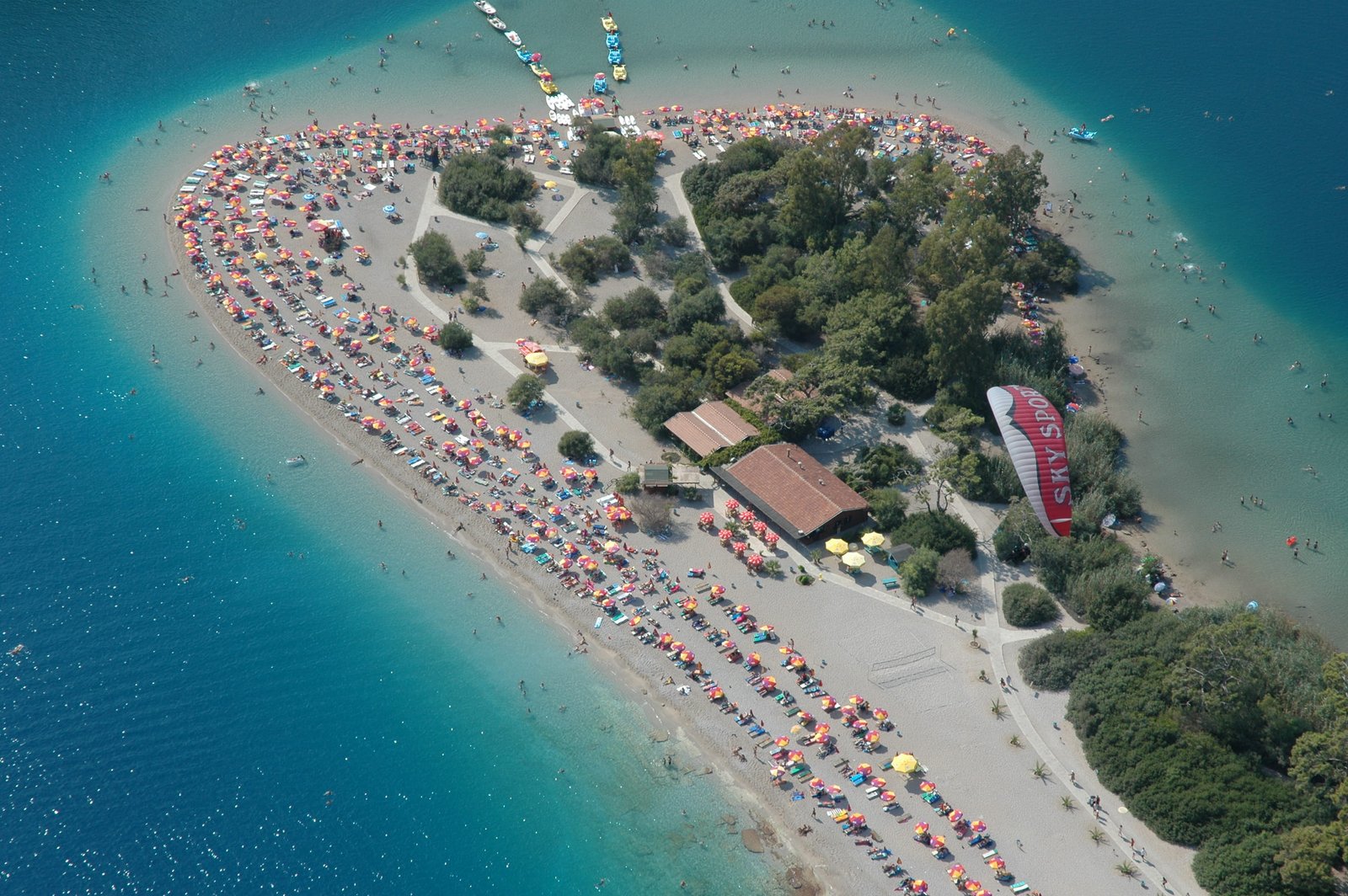 Drone view of a crowded sand beach in l deniz Fethiye Blue Lagoon 2k
