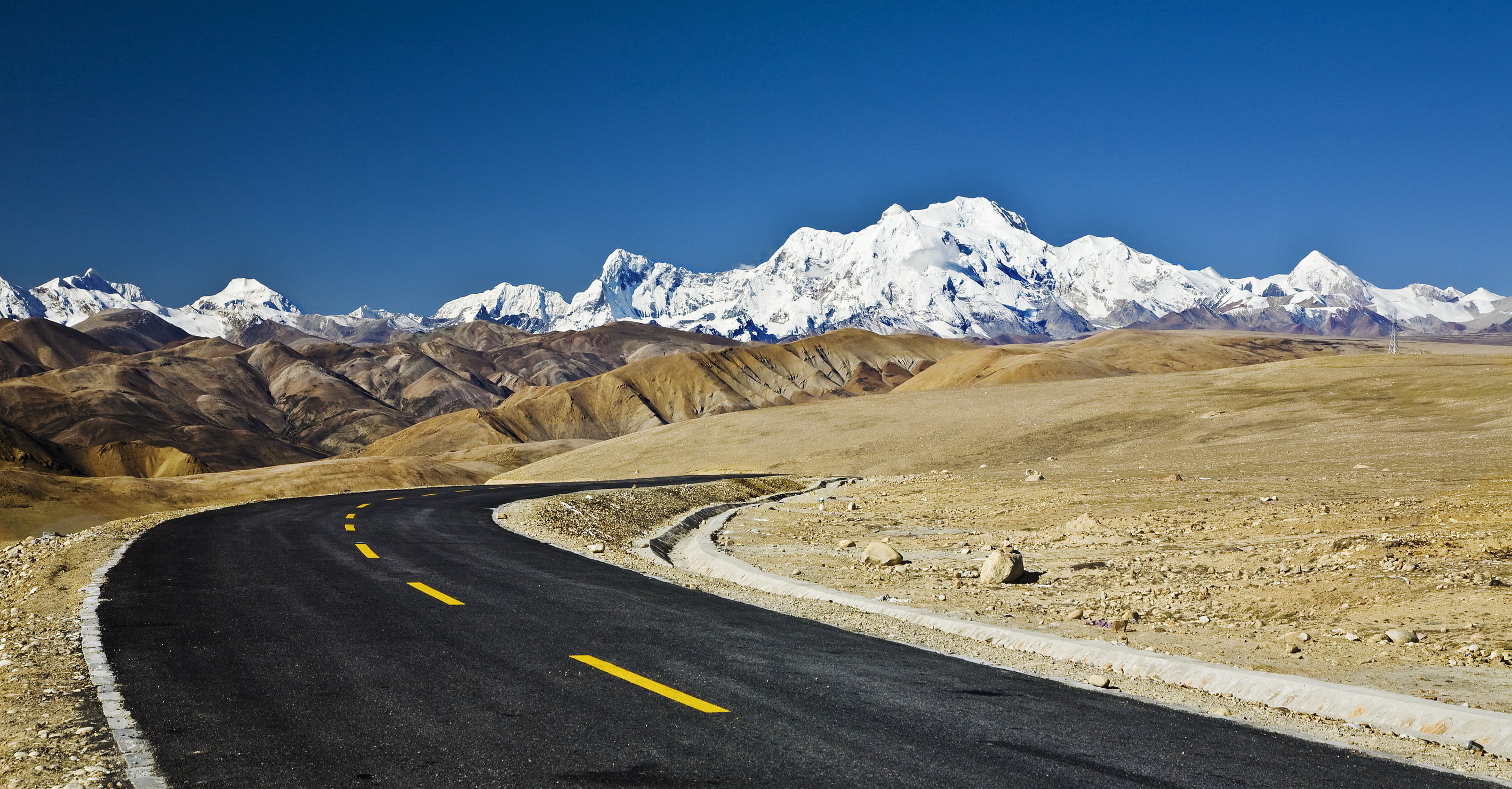 whining road going to snow top mountain Friendship highway Himalaya 2k