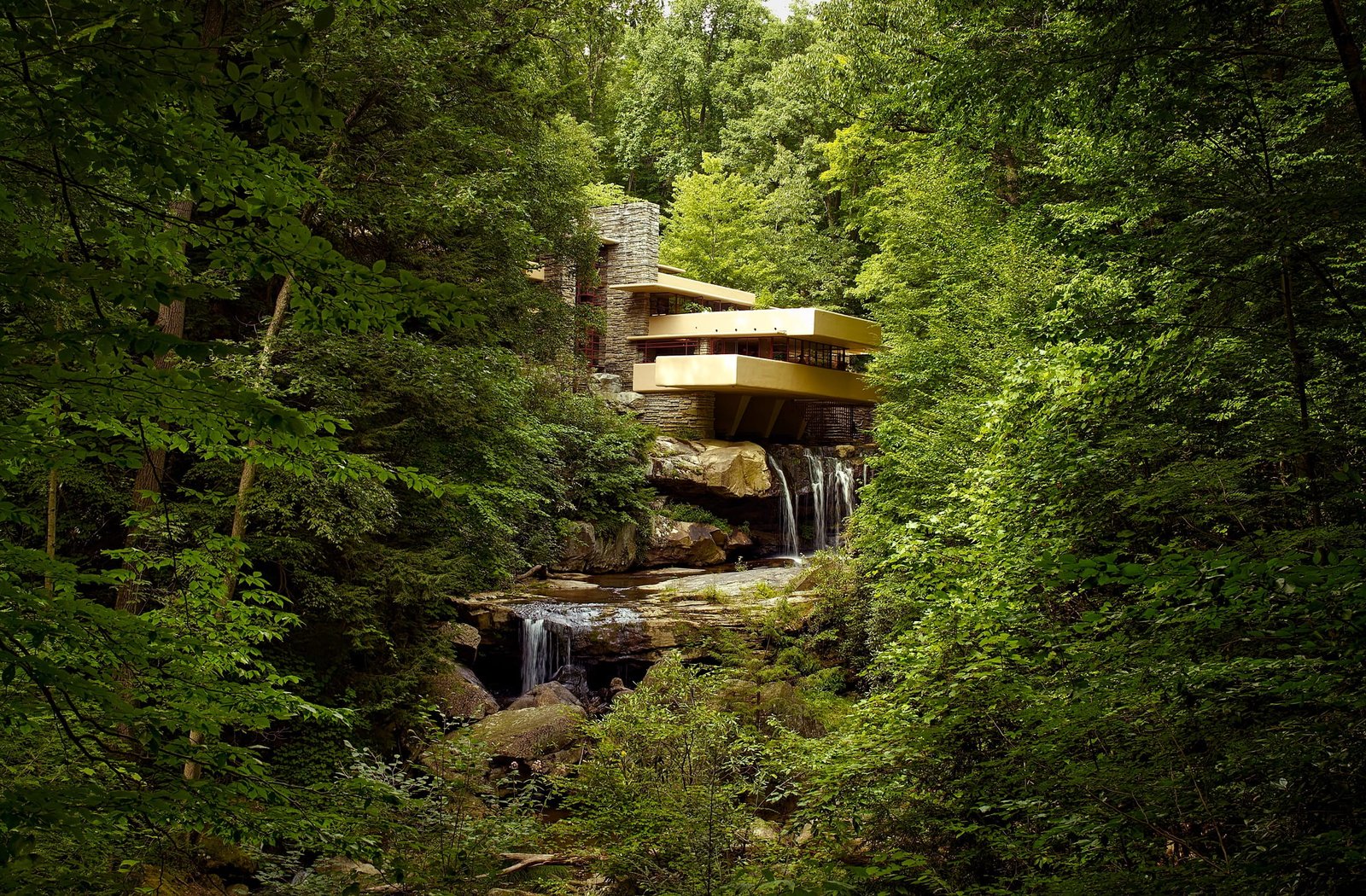 brown house on the middle of forest with water fountain during daytime 2k