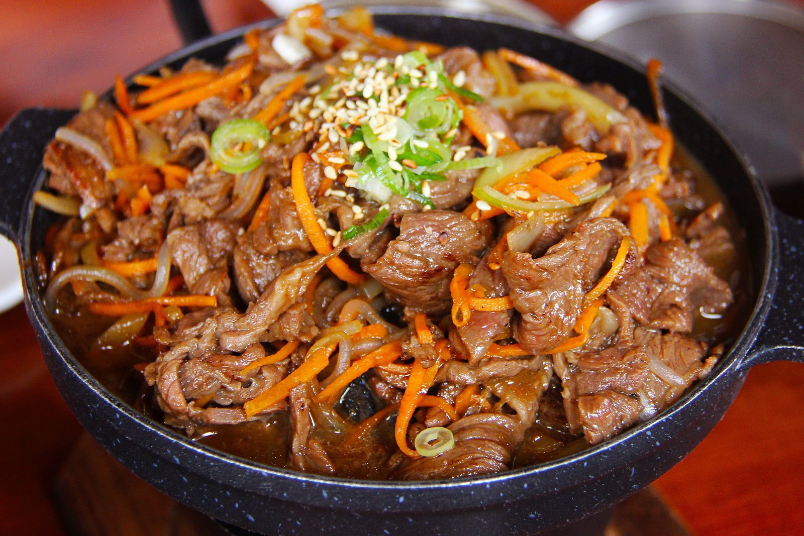 cook food on black cooking pot pork meat fried korean 2k