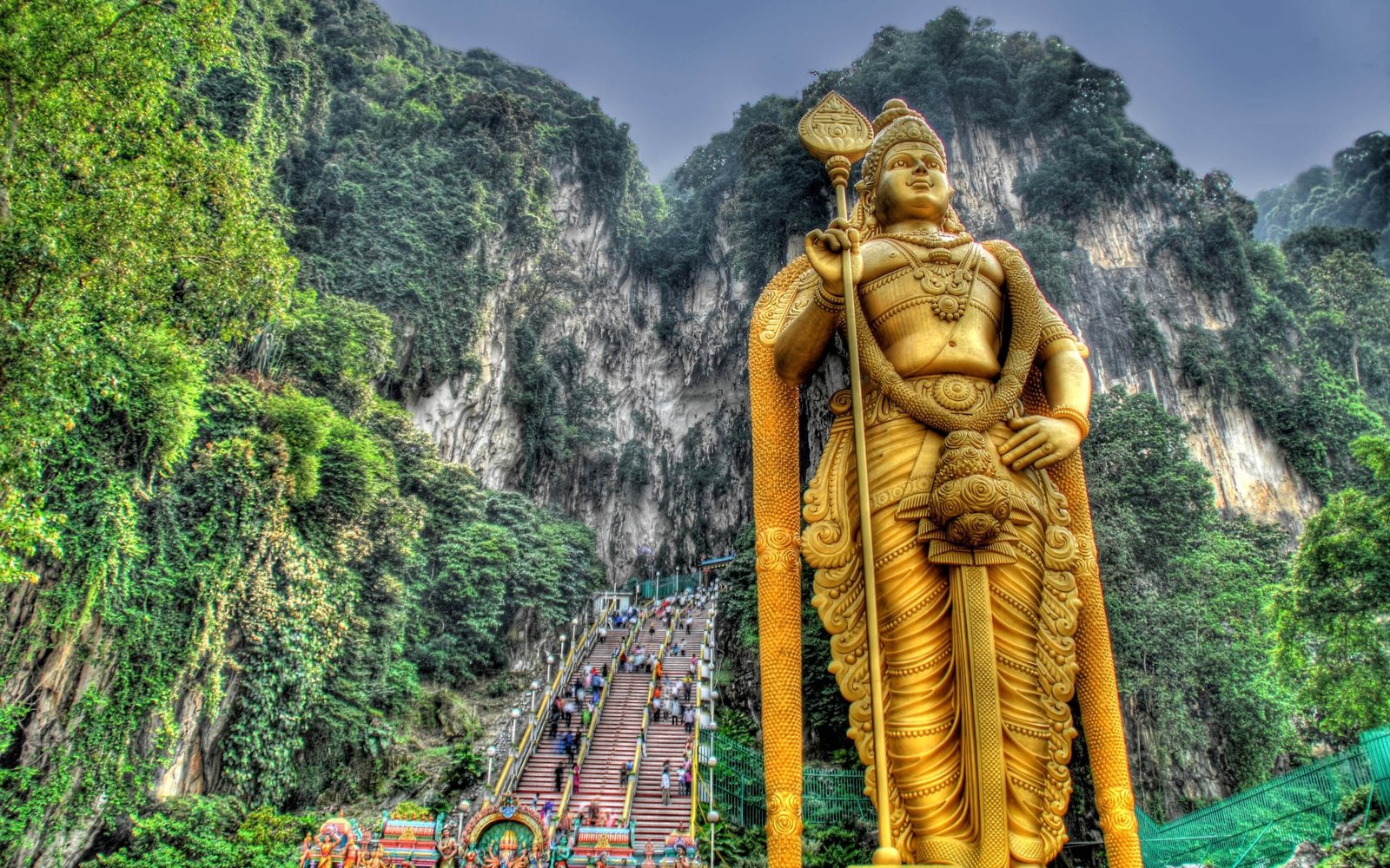 gold Hindu god statue murugan malaysia stairs hills people 2k
