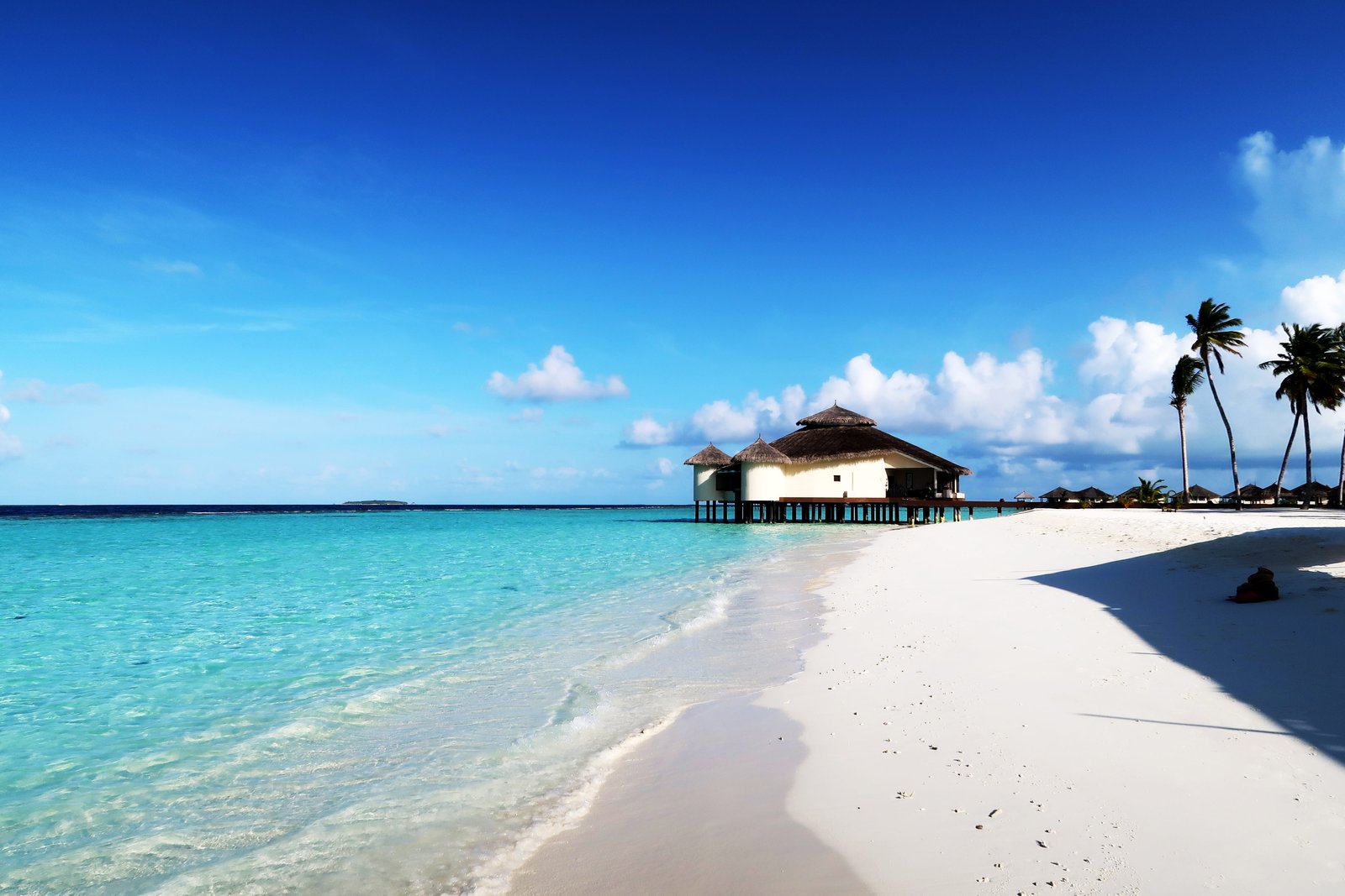 brown wooden hut above body of water Maldives Beach Relax 2k 4k 5k