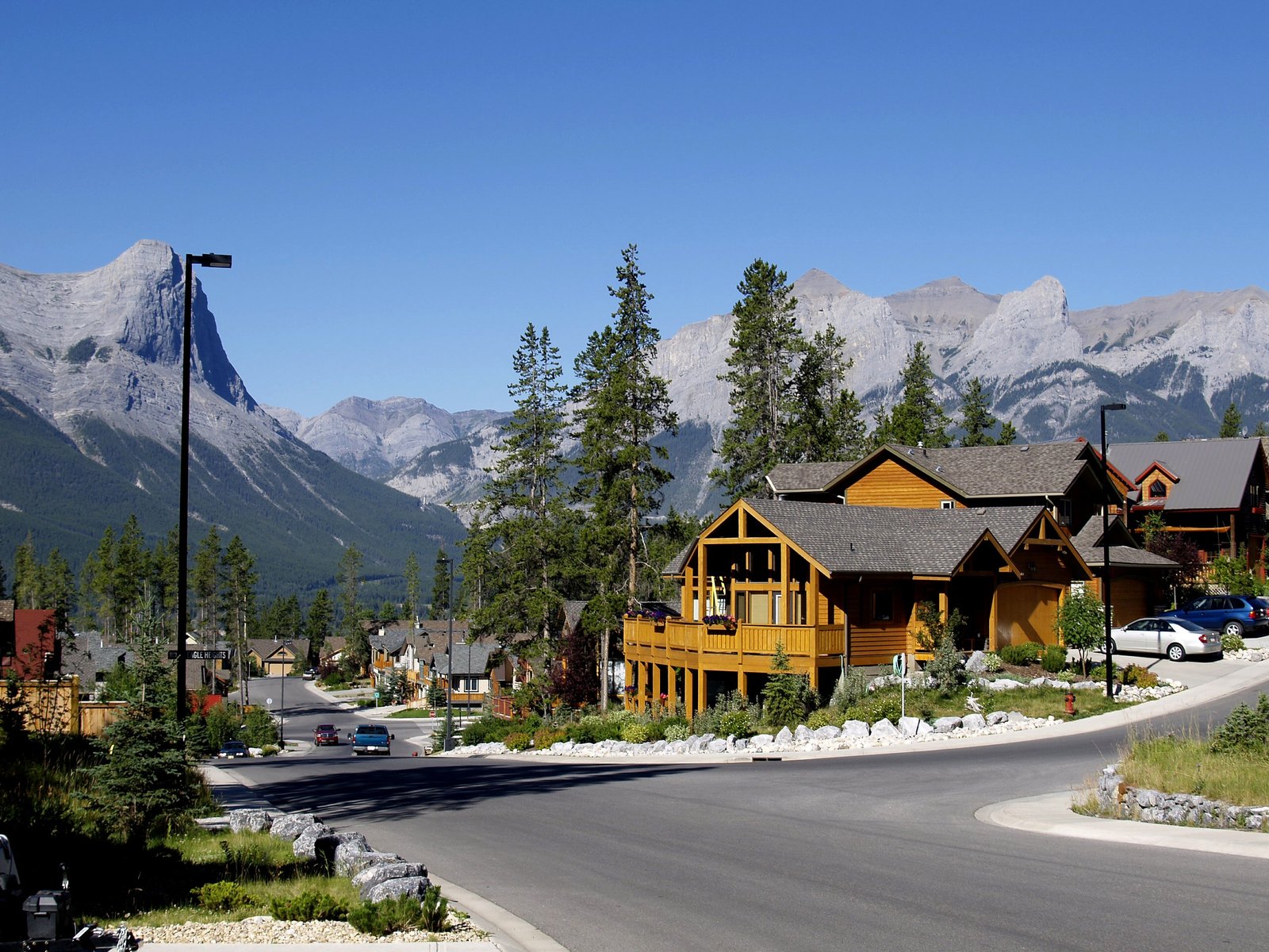 concrete road at middle of houses canmore city town rocky mountains 2k