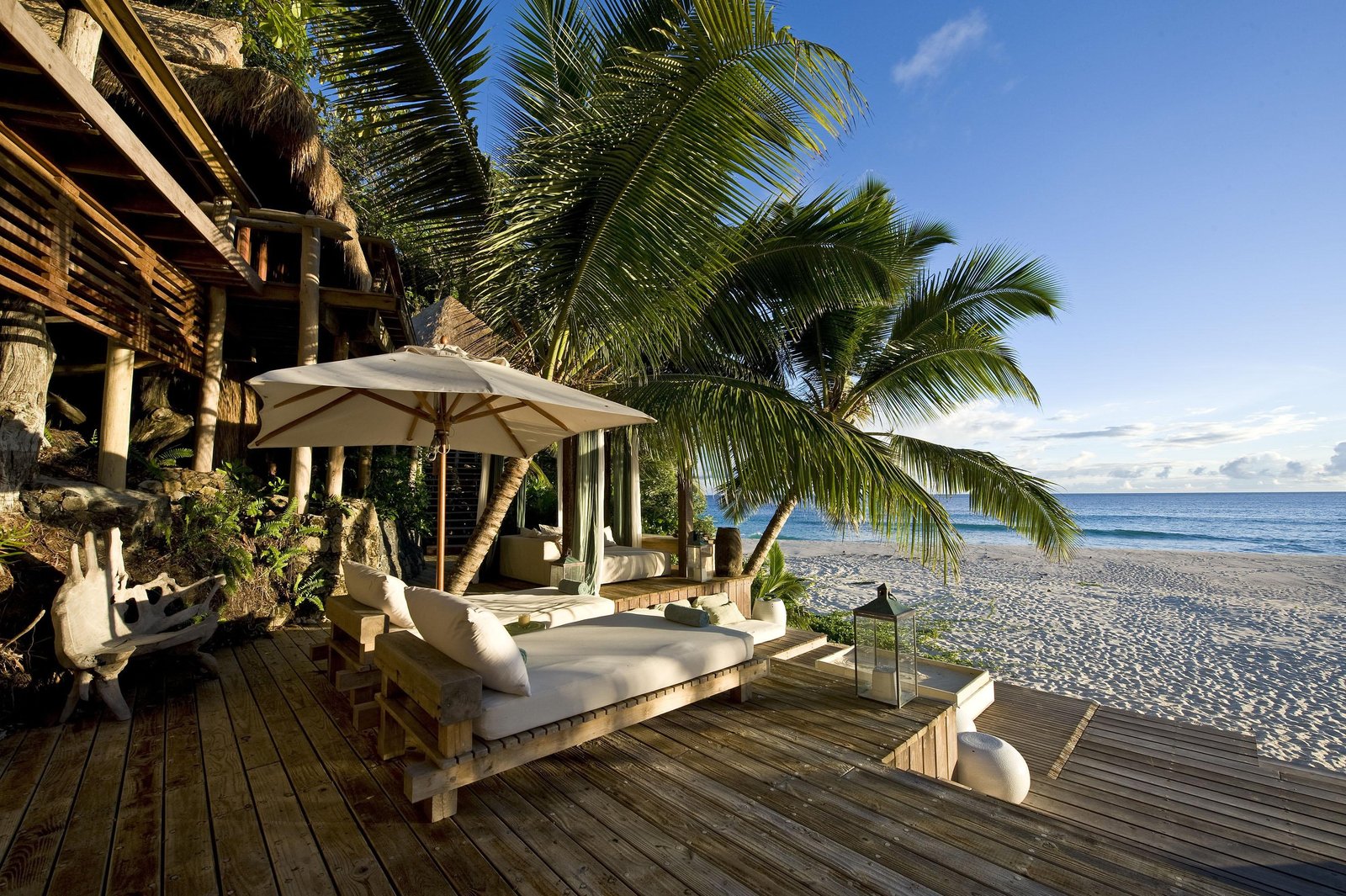 Relaxing Evening Beach brown wooden frame lounge chairs view 2k
