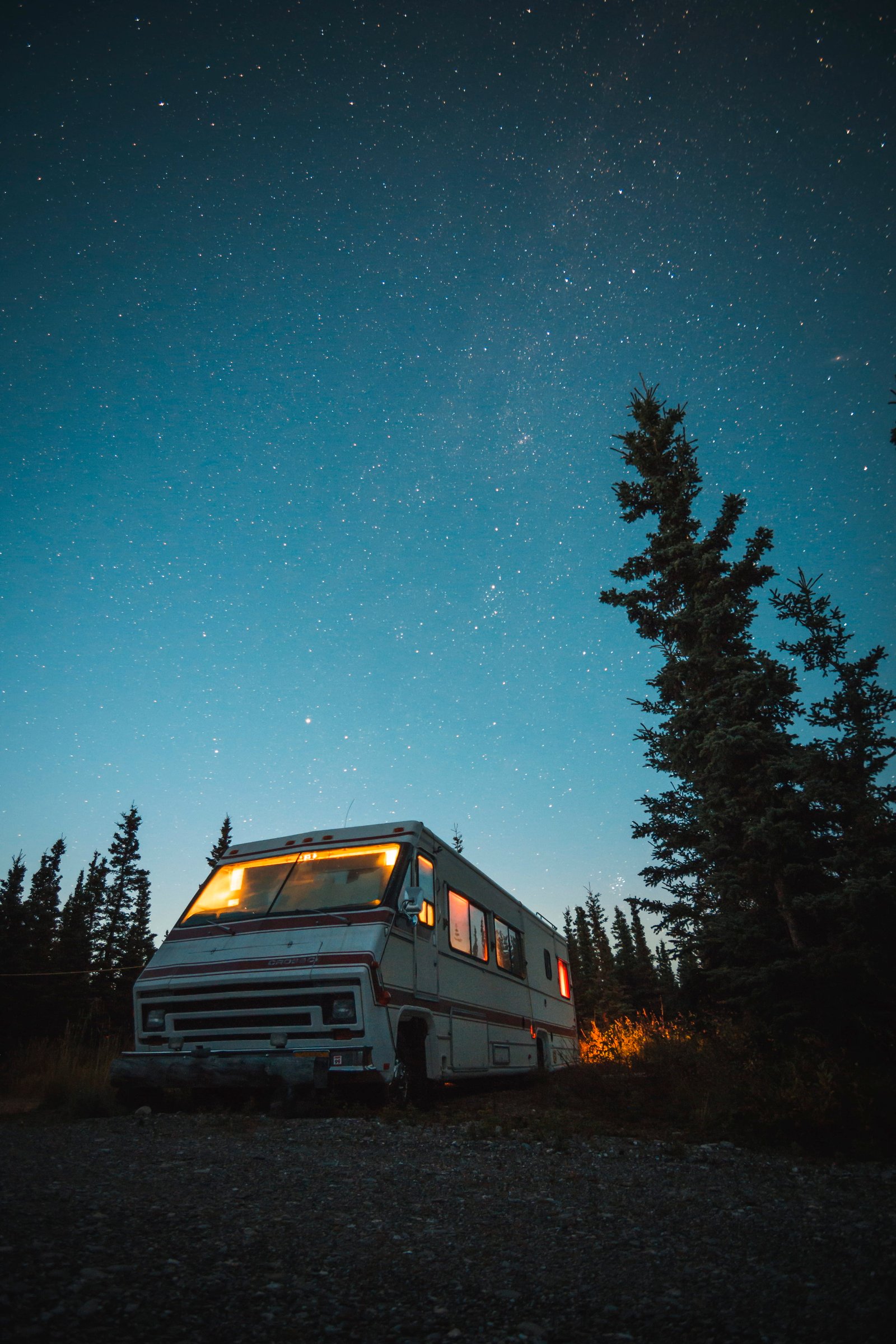 white and red RV beside trees van night sky camper star 2k 4k