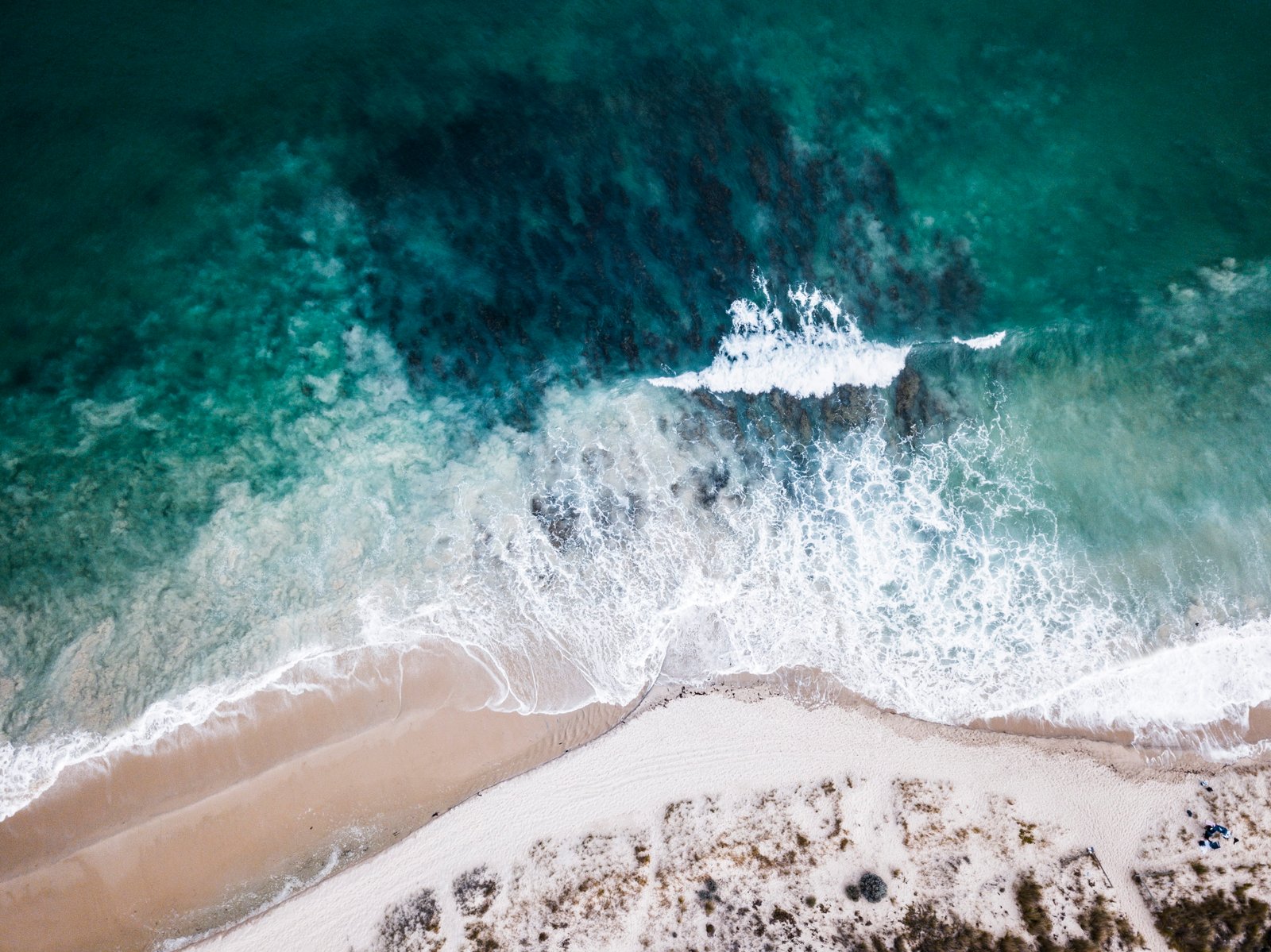 high angle photo of ocean waves crashing on shore sea white and brown 2k 4k
