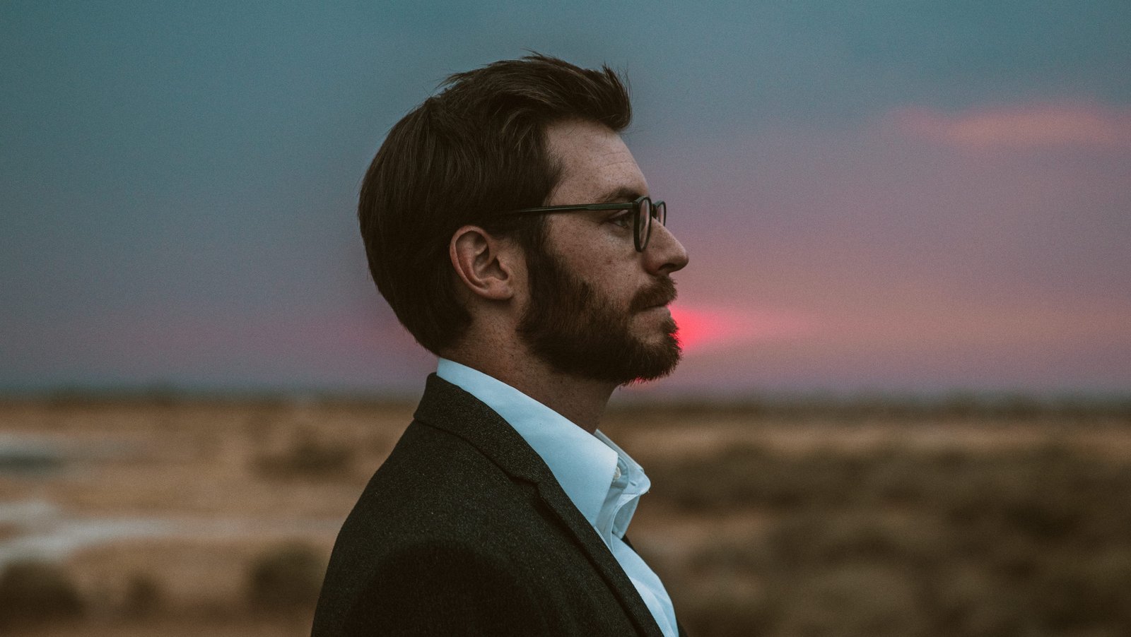 man in black formal suit wearing eyeglasses side profile face 2k 4k 5k