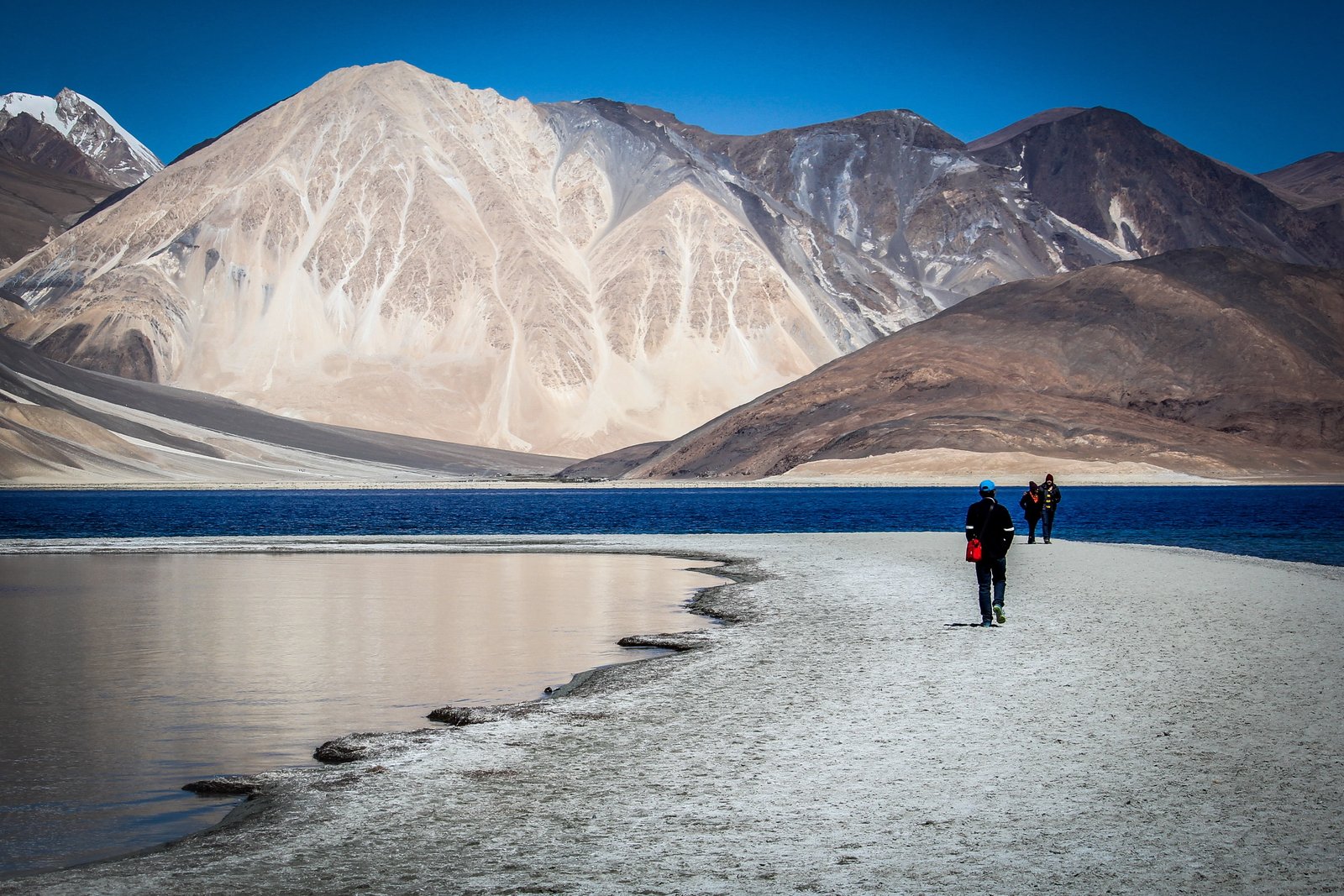 photo of person walking on pathway near mountain ladakh traveler 2k 4k