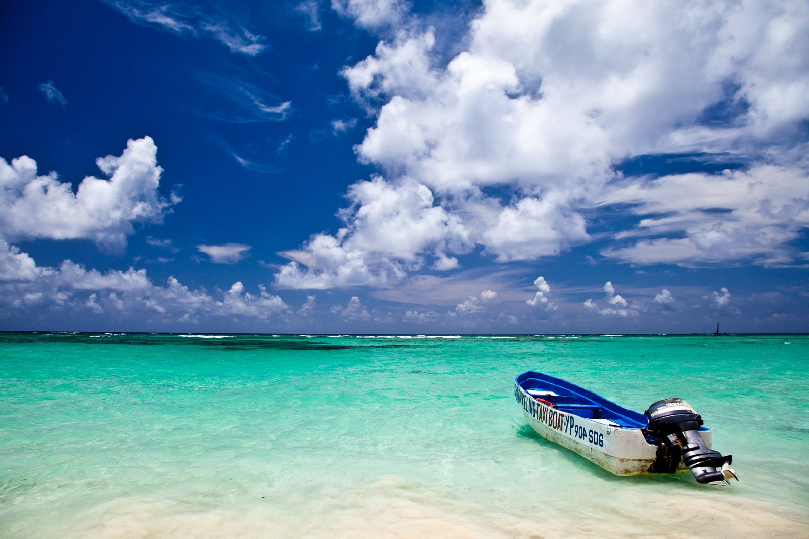 white and blue speedboat on ocean under sky during daytime punta cana dominican republic 2k 4k 5k