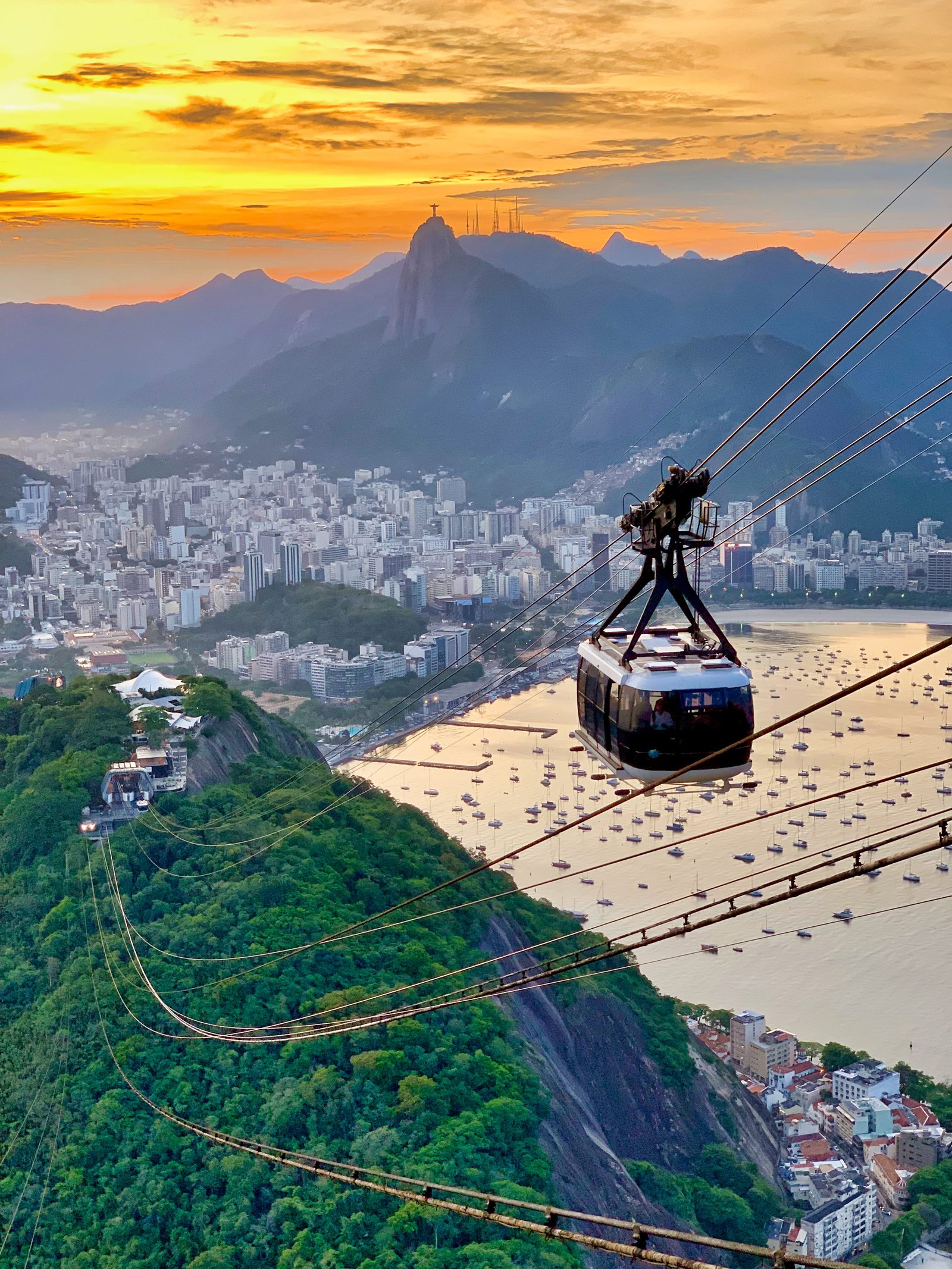 white cable car traversing on top of hills overlooking city by bay 2k