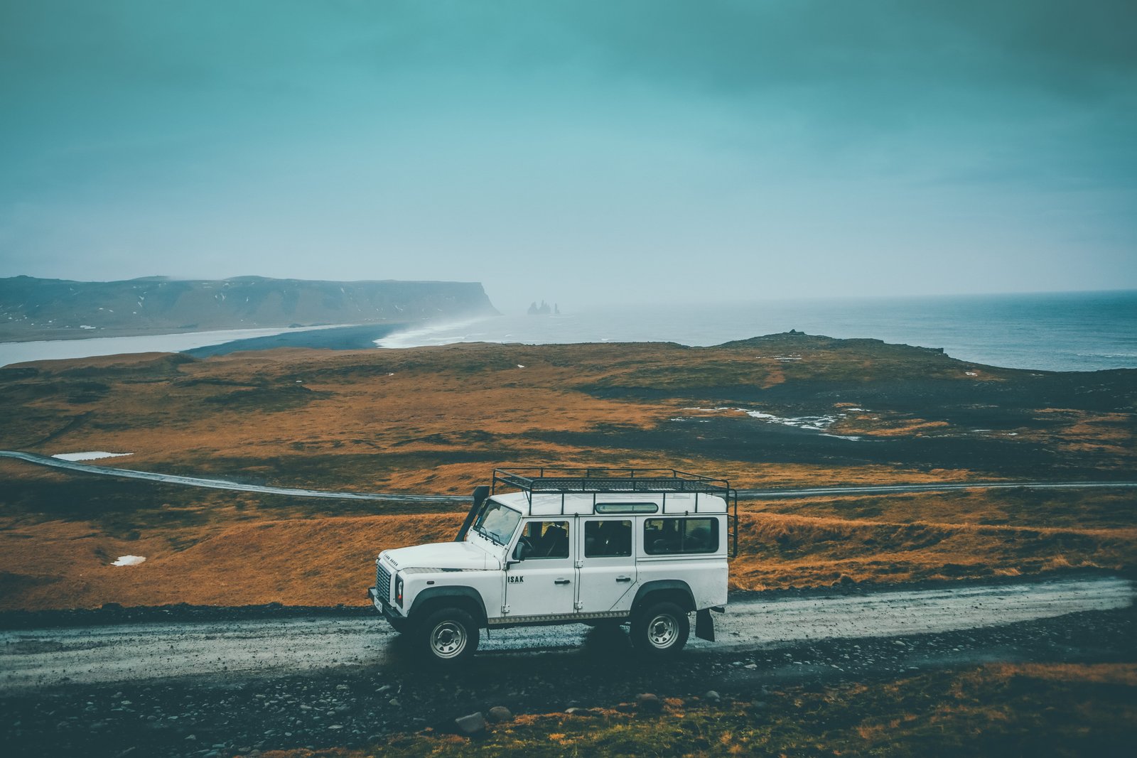 white Jeep SUV on gray rocky road during daytime running pave 2k 4k 5k