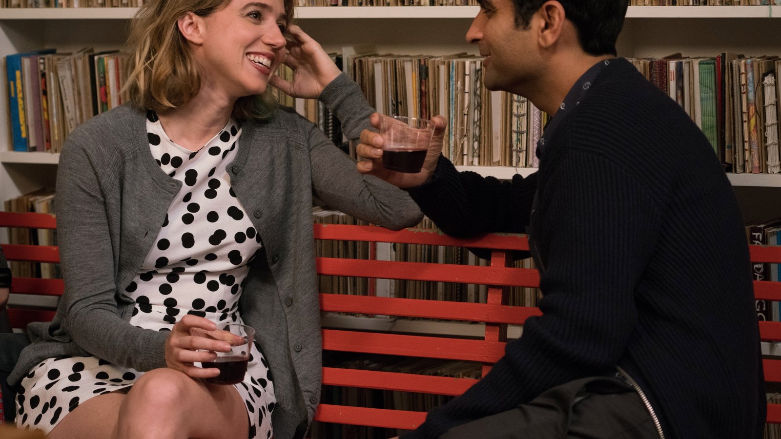 blonde haired woman wearing white and black polka dots dress sitting on red couch 2k 4k 5k