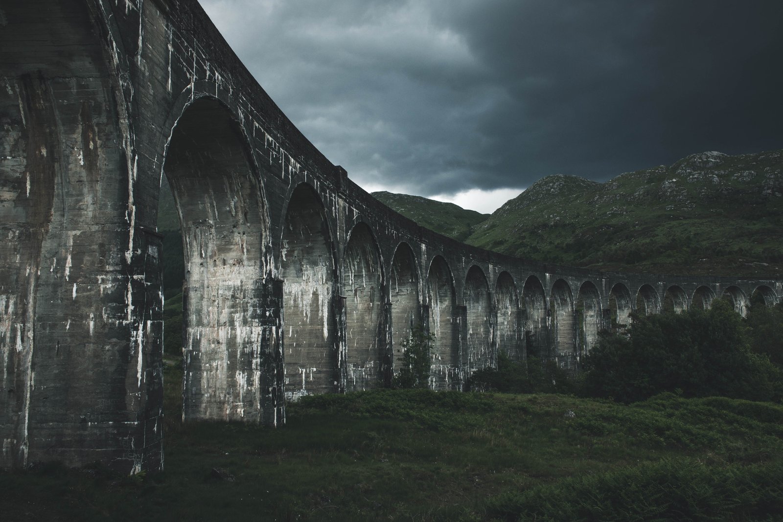 grey concrete bridge near hills landscape photography of mountain 2k 4k 5k