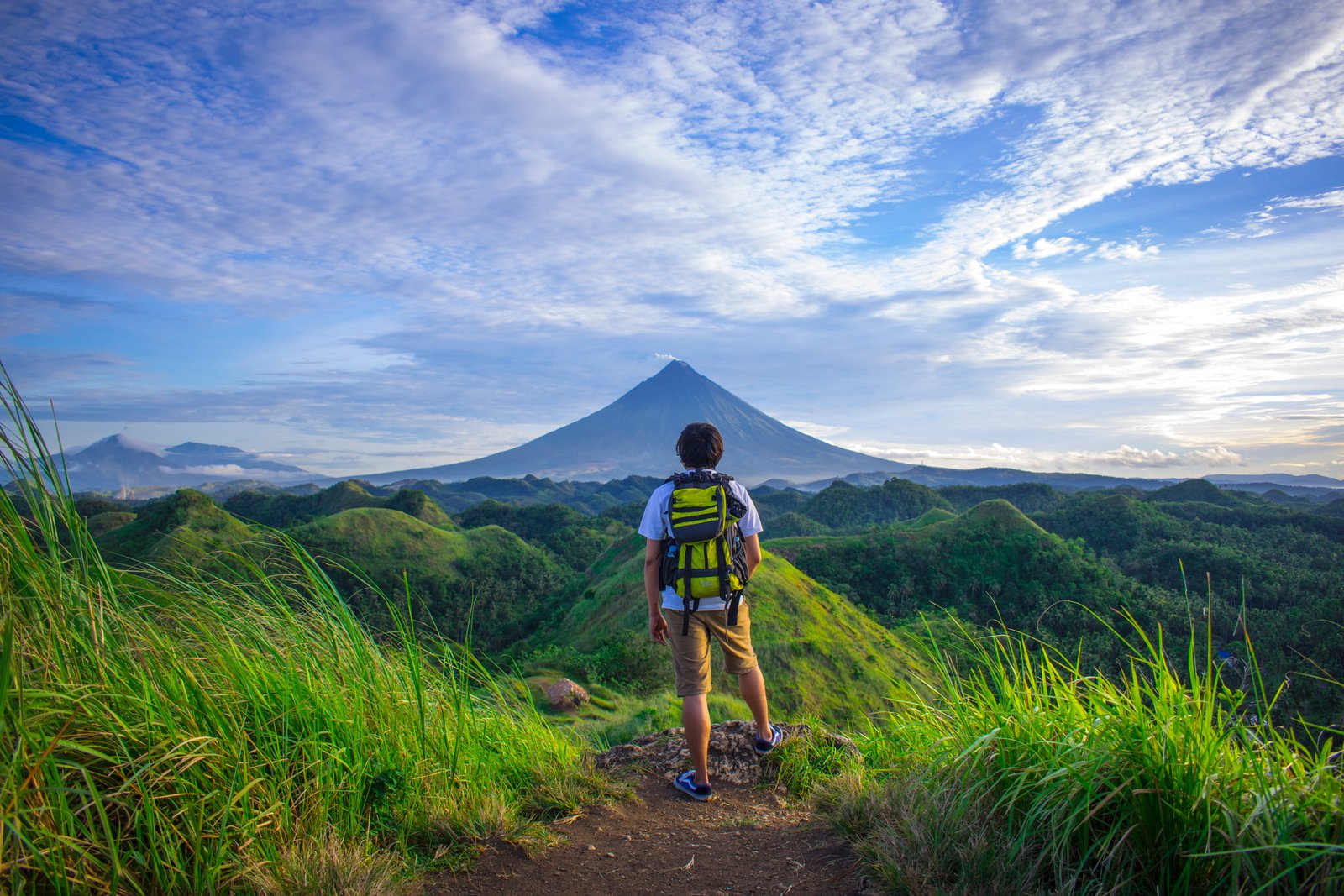 Man Wearing White Shirt Brown Shorts and Green Backpack Standing on Hill 2k 4k 5k