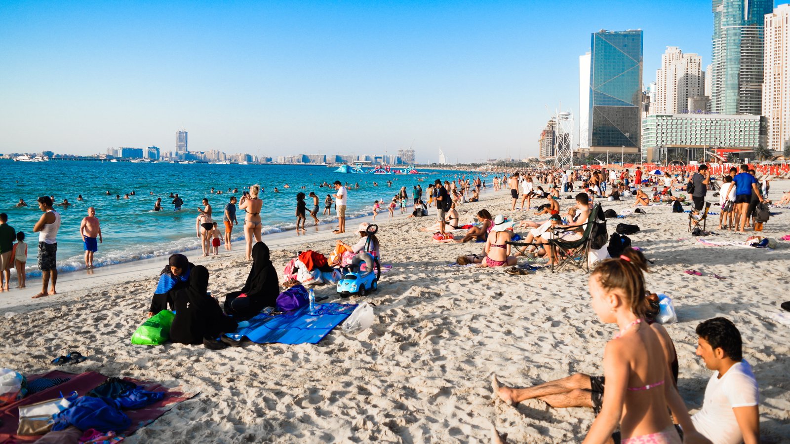 People Near Sea beach blue sky buildings children dubai 2k 4k 5k