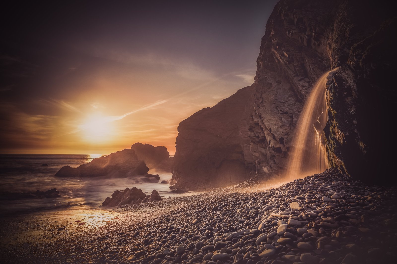 waterfalls on rocky mountain near seashore during sunset bude 2k 4k 5k