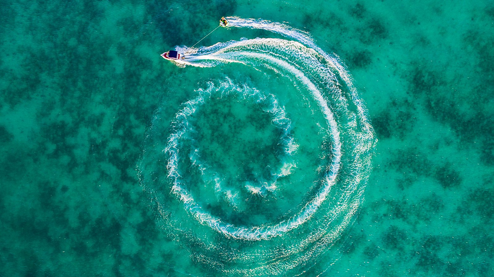 two boats on calm body of water top view photography speedboat maneuvering while pulling person wakeboard 2k 4k 5k