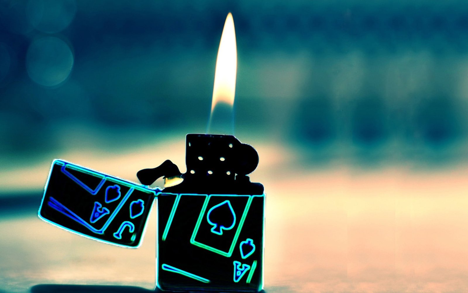 black and blue flip lighter lighted on brown surface 2k