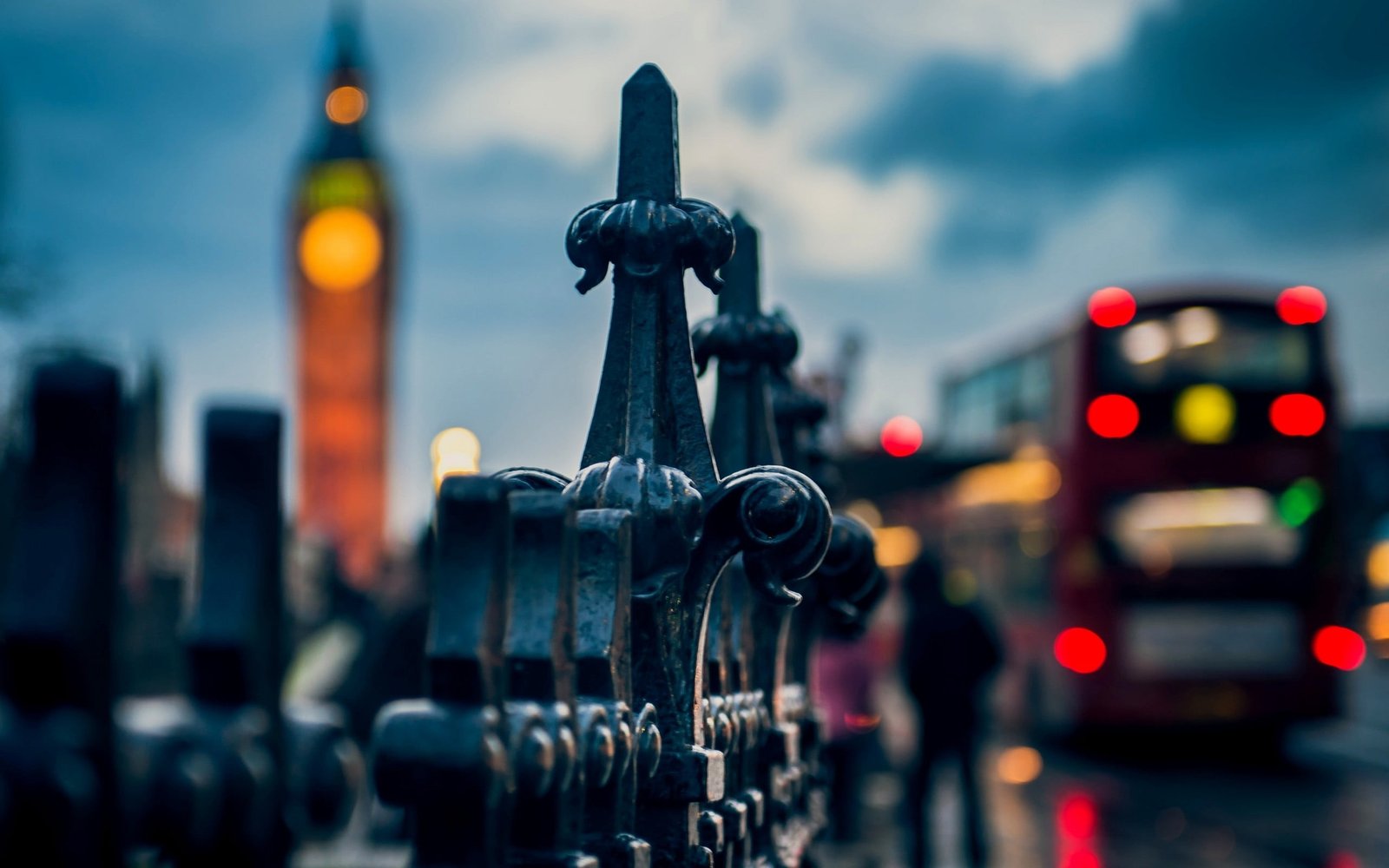 black metal fence selective focus bokeh photography of finaials 2k