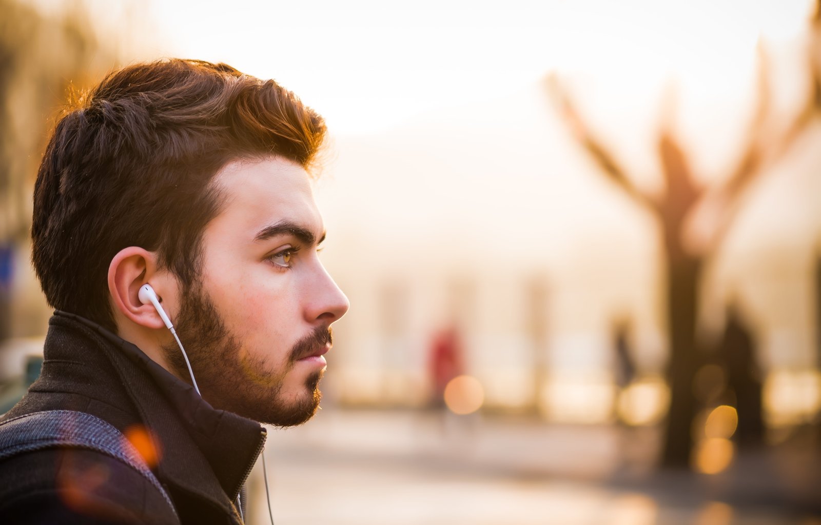 bokeh lights photography of man listening to in ear earphones wearing black turtleneck coat and earbuds selective focus 2k 4k 5k