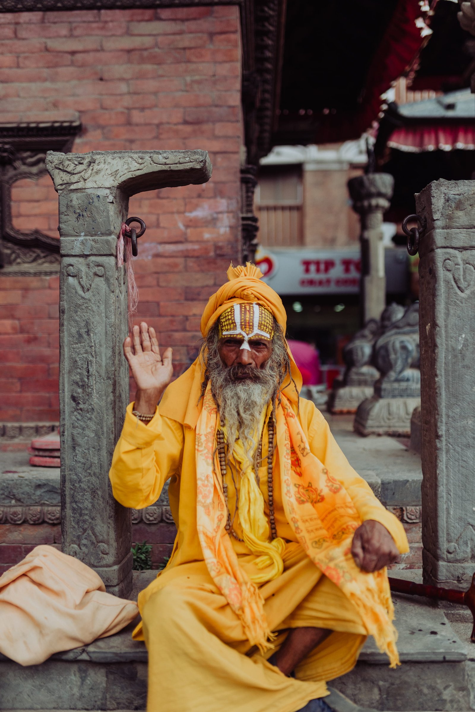 man wearing yellow long sleeved coat sitting near pillar old 2k