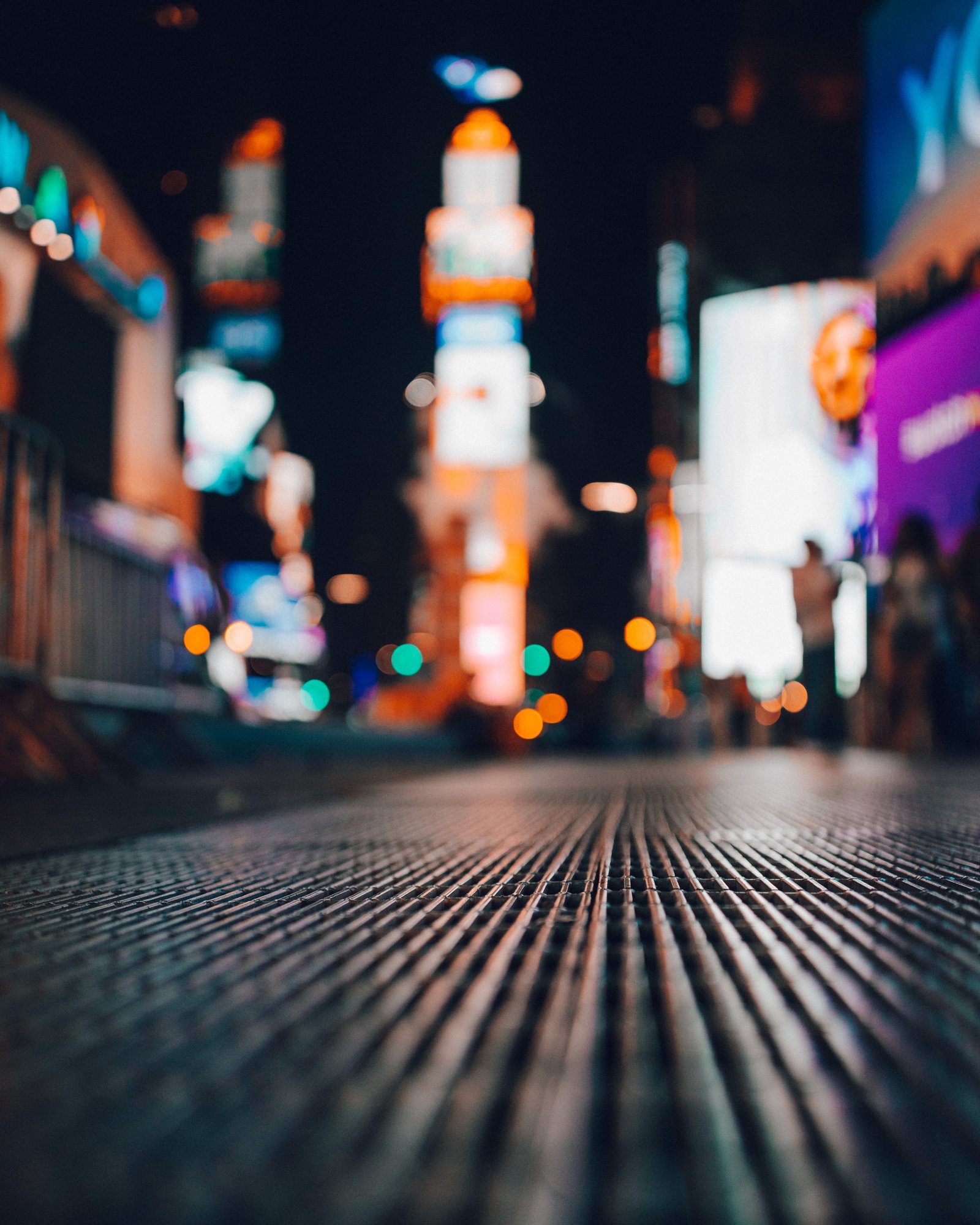 shallow focus of drainage cover during daytime city view at night time blurry photography 2k 4k