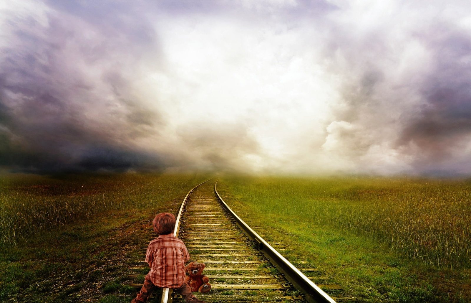 boy sitting on train rail under cloudy sky lighting color nuances 2k