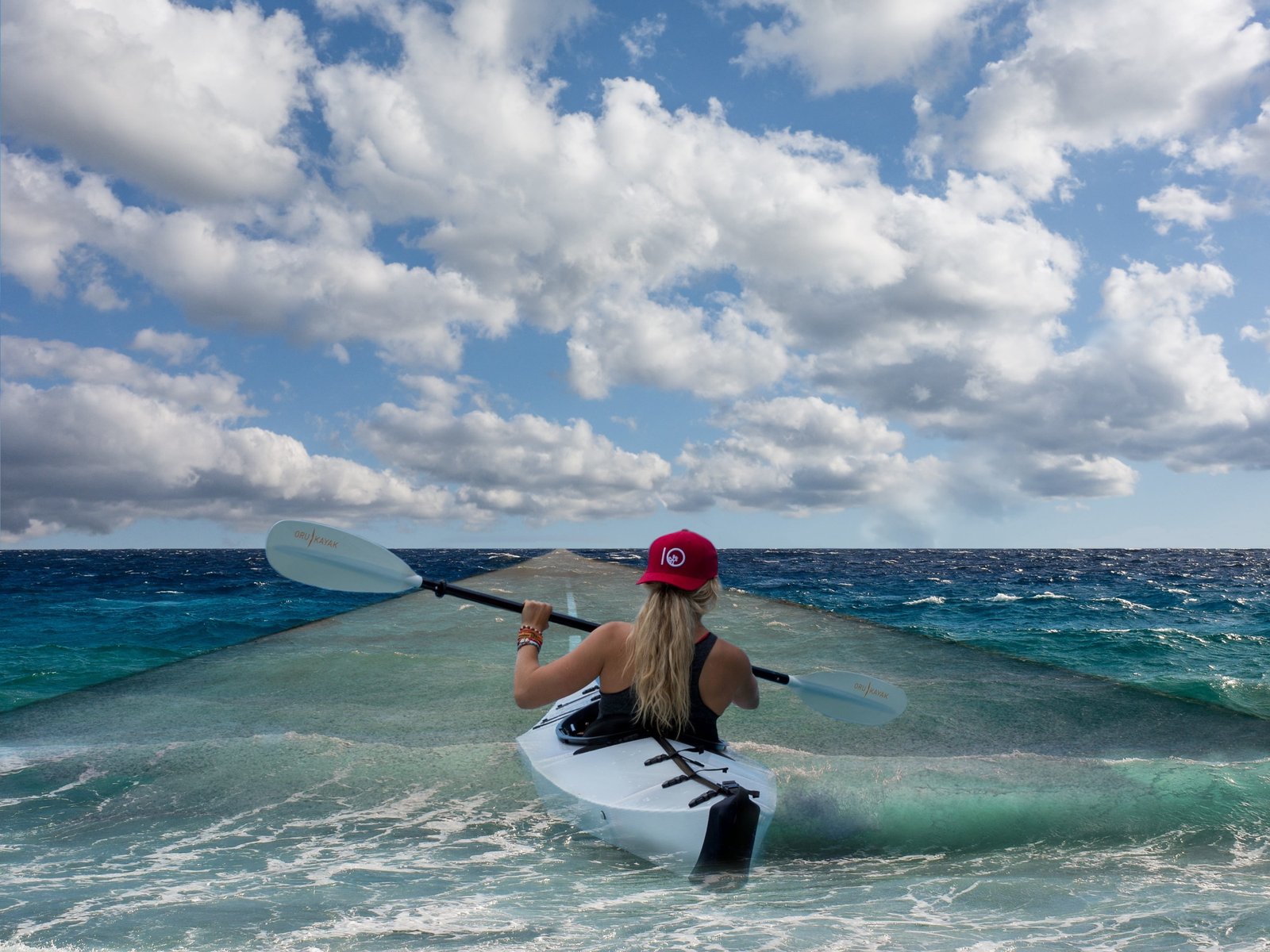 woman wearing black racerback tank top on white kayak under clouds 2k 4k