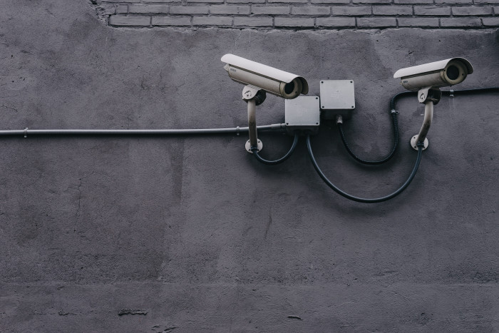 Two Gray Bullet Security Cameras cyber data equipment pavement 2k 4k 5k