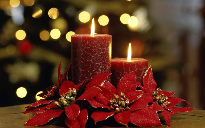 two red pillar candles flowers bokeh holiday Christmas decorations