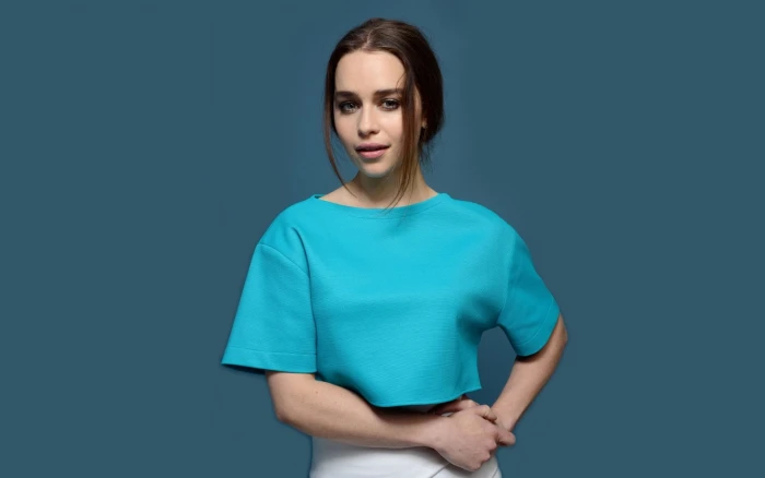 Actresses Emilia Clarke studio shot blue colored background