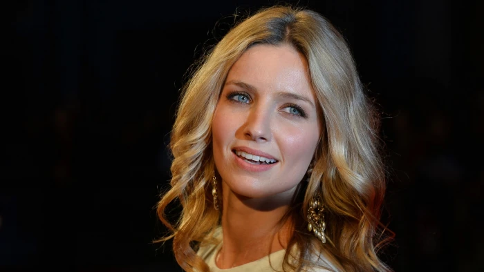Annabelle Wallis blonde black background blue eyes face