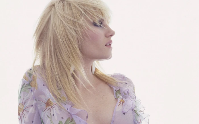 portrait photography of woman wearing purple and white floral top