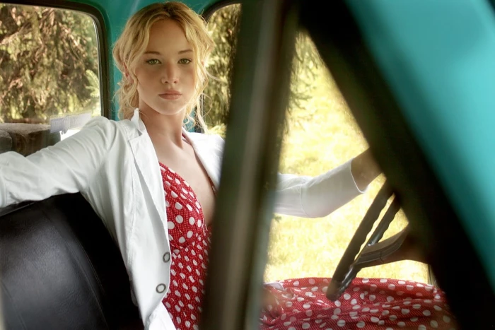 woman in red and white polka dot dress blazer sitting inside vehicle