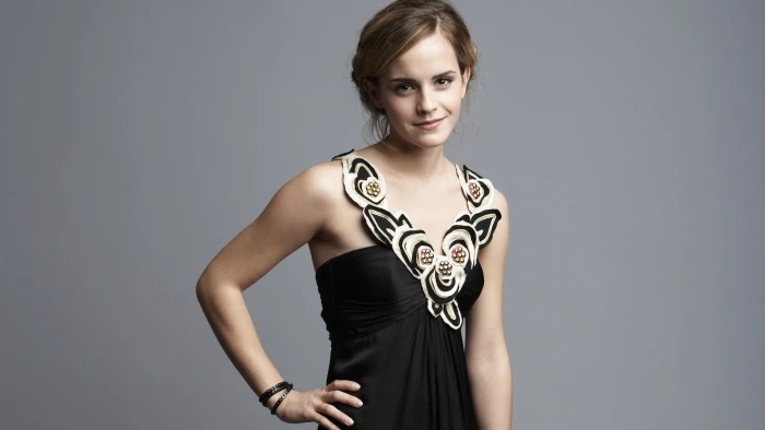 woman wearing black and white sleeveless shirt hands on hips