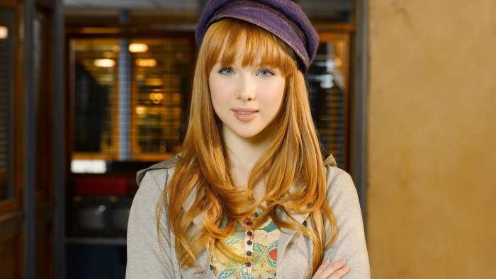 women's purple cap and grey cardiga model redhead face blue eyes